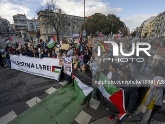 Activists are carrying Palestinian flags and banners as they march during a protest in central Lisbon, Portugal, on February 10, 2024. The p...