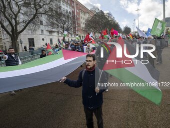 Activists are carrying Palestinian flags and banners during a rally in central Lisbon, Portugal, on February 10, 2024. The protest action is...