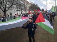 Activists are carrying Palestinian flags and banners during a rally in central Lisbon, Portugal, on February 10, 2024. The protest action is...