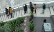 People are looking at a cloudy London from the Sky Garden at the top of a skyscraper on Fe...
