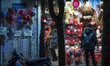 An Iranian man is looking at a shop window decorated for Valentine's Day shopping in downt...