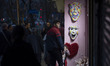 An Iranian man and his child are standing in front of a shop decorated for Valentine's Day...