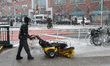 A worker is plowing snow off the sidewalk in Union Square after a winter storm hit New Yor...
