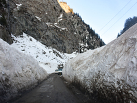 Vehicles are passing through a snow tunnel on a sunny winter day in Sonmarg, a tourist destination in the Ganderbal district of Jammu and Ka...