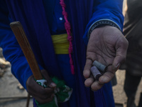 A farmer is holding rubber bullets in his hands that were fired at protesting farmers by the police as they march towards New Delhi demandin...
