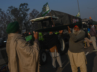 A farmer is wearing a turban, also known as a Pagri, next to the tractors and trolleys parked as the farmers are marching towards New Delhi...