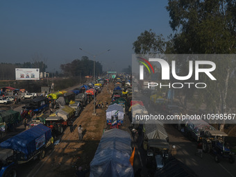 Tractors and trolleys are parked on a national highway while farmers are marching towards New Delhi to demand the Minimum Support Price (MSP...