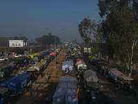 Tractors and trolleys are parked on a national highway while farmers are marching towards New Delhi to demand the Minimum Support Price (MSP...