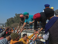 Volunteers are distributing food to farmers on a national highway as the farmers march towards New Delhi to demand the Minimum Support Price...
