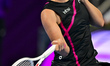 Iga Swiatek of Poland is in action during her quarter-final match against Victoria Azarenk...