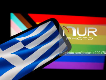 The flag of Greece is being displayed on a smartphone screen, and an LGBTQ flag is being shown on a MacBook screen in Athens, Greece, on Feb...
