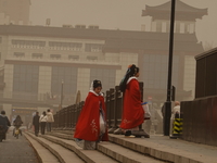 Pedestrians are walking on a street during dusty weather in Xi'an, Shaanxi Province, China, on February 18, 2024. It is understood that at 6...