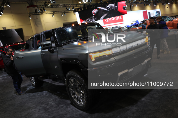 Visitors are looking at the Hummer SUV Electric vehicle exhibited at the Canadian International Auto Show in Toronto, Canada, on February 19...