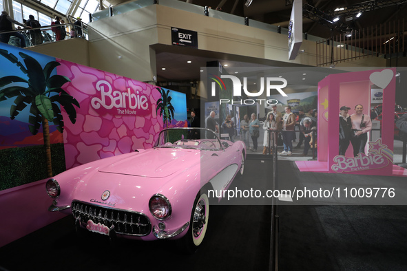 People are taking photos of a Barbie-themed convertible at the Canadian International Auto Show in Toronto, Canada, on February 19, 2024. 