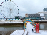 Tourists are visiting the Rainbow Bridge after snowfall in the West Coast New Area of Qingdao, Shandong Province, China, on February 20, 202...