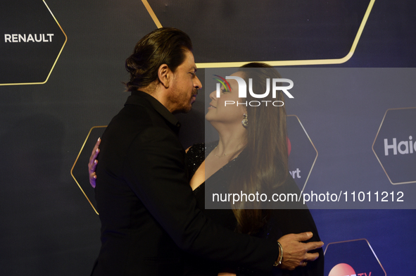Bollywood actor Shah Rukh Khan (L) and Bollywood actress Rani Mukherji (R) are hugging each other during a photoshoot at a red carpet event...