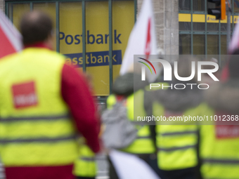Employees from Postbank branches are marching past a Postbank branch during the strike in Essen, Germany, on February 21, 2024, as the Verdi...
