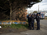 Gendarmes Mobiles are standing guard near the 'Crem'Arbre' ZAD in Saix, Tarn, France, on February 21, 2024. The graffiti reads 'A world with...