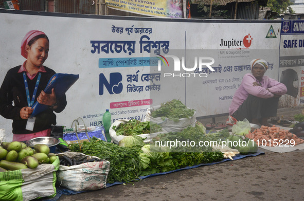 An Indian vegetable vendor is selling vegetables at a roadside stall in Siliguri, India, on February 22, 2024. 
