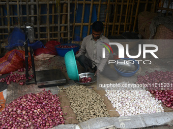 An Indian vegetable vendor is selling onions, ginger, and other vegetables at a roadside stall in Siliguri, India, on February 22, 2024. (