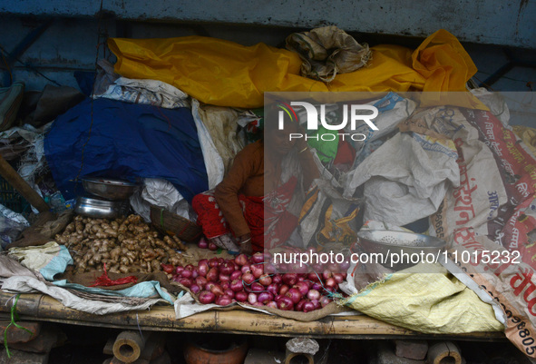 An Indian vegetable vendor is selling onions, ginger, and other vegetables at a roadside stall in Siliguri, India, on February 22, 2024. 