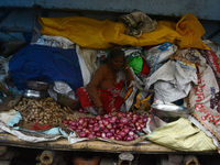 An Indian vegetable vendor is selling onions, ginger, and other vegetables at a roadside stall in Siliguri, India, on February 22, 2024. (