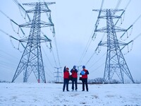 Electric workers are braving cold temperatures in the snow to inspect the 500-kilovolt cross-city transmission line and the Beijing-Shanghai...