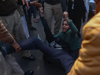 Activists are shouting slogans while police personnel are detaining them during a protest against the killings of farmers in clashes with th...