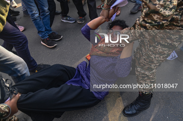 An activist is reacting as police personnel detain her during a protest against the killings of farmers in clashes with the police at the bo...