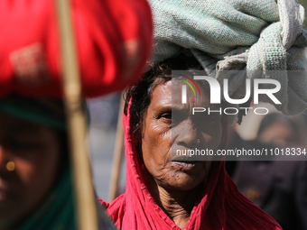 A Nepali loan shark victim is carrying her belongings on her head as she takes part in the march leading to the administrative capital of th...
