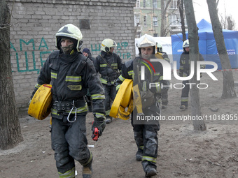 Rescuers are standing near a block of flats in Dnipro, Ukraine, on February 23, 2024, that was hit by a Russian Shahed drone during an overn...