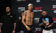 Edgar Chairez of Mexico is posing on the scale during the UFC Fight Night ceremonial weigh...