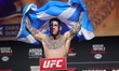 Chris Duncan of Scotland is posing on the scale during the UFC Fight Night ceremonial weig...