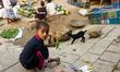 A kid was trying to feed goats at the wholesale market at Sadarghat in Dhaka, Bangladesh o...