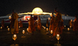 Thai Buddhist monks are walking in a circular procession with lanterns to celebrate Makha...