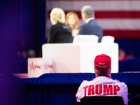 A Trump supporter listens to a panel on the Bible at the annual Conservative Political Action Conference (CPAC) in National Harbor, MD, Febr...