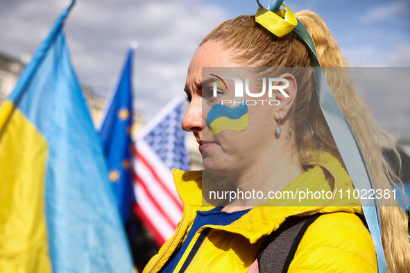 A woman attend the march ' Together For Victory ' to show solidarity with Ukraine and commemorate two year anniversary of Russian invasion o...