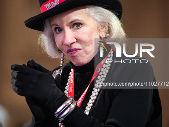 A woman in Trump-inspired attire applauds Steve Bannon at the annual Conservative Political Action Conference (CPAC) in National Harbor, MD,... by Allison Bailey/NurPhoto