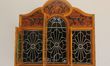 Decorative wooden designs are surrounding a window on a fancy home in Jaffna, Sri Lanka. 