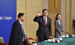 Chinese Minister of Environmental Protection Chen Jining (C) greets journalists during a p...
