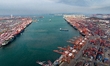 Containers are being loaded and unloaded at the Qianwan Container Terminal of Qingdao Port...