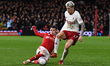 Neco Williams of Nottingham Forest is tackling Alejandro Garnacho of Manchester United dur...