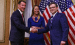 Speaker Mike Johnson is swearing in Rep. Mike Suozzi as his wife Helene Suozzi looks on du...