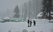 People are taking pictures amid heavy snowfall at a ski resort in Gulmarg, Baramulla Distr...