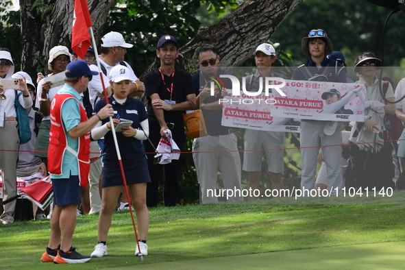 Fans of Ayaka Furue from Japan are watching her during the third round of the HSBC Women's World Championship at Sentosa Golf Club in Singap...