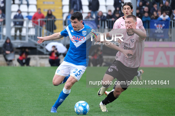 Dimitri Bisoli of Brescia Calcio FC is being followed by Kristoffer Lund during the Italian Serie B soccer championship match between Bresci...