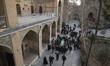 Unidentified men are carrying a coffin covered with a religious flag that contains the bod...