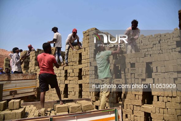Labourers are working at a brick factory on the outskirts of Guwahati, India, on March 7, 2024. 
