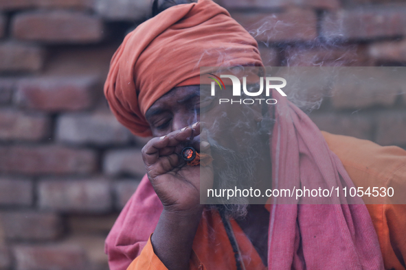 A Sadhu, or Hindu holy man, is smoking marijuana on the premises of Pashupatinath Temple in Kathmandu, Nepal, on the eve of Maha Shivaratri,...