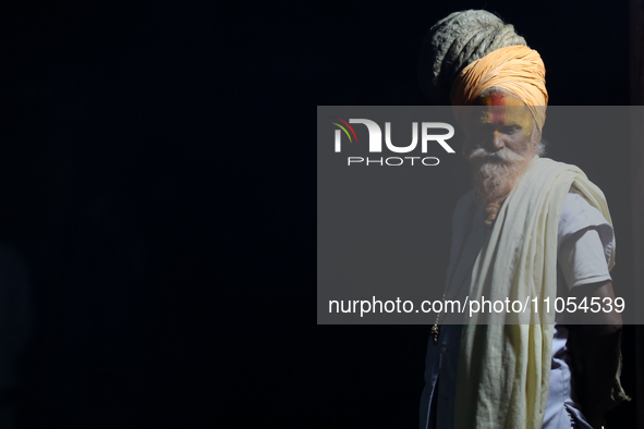A Sadhu, or Hindu holy man, is being pictured on the premises of Pashupatinath Temple on the eve of Maha Shivaratri in Kathmandu, Nepal, on...